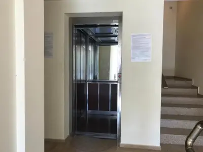 a black elevator in a building with stairs at Relax Apartment am Südstrand in Primorsko