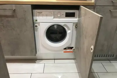 a washer and dryer sitting in a kitchen at Relax Apartment am Südstrand in Primorsko