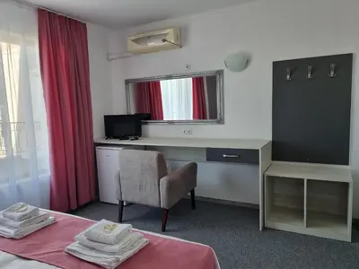 a room with a desk and a chair and a window at Dani beach Sozopol in Sozopol