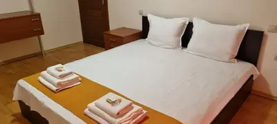 a bedroom with a bed with towels on it at Dani beach Sozopol in Sozopol