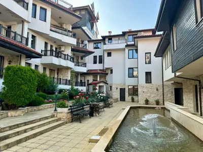 a courtyard with a pond in front of a building at Sozopol Dreams - Apartment №41 in Sozopol