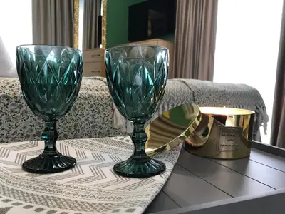 two green glasses sitting on top of a table at Аpartment Bella Vista in Obzor