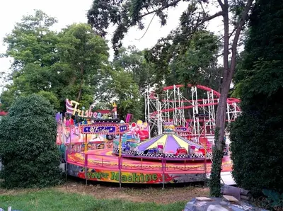 a carnival ride in a park with a roller coaster at Hotel Largo Beach in Sunny Beach