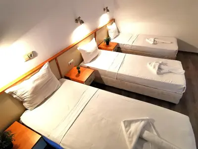 a hotel room with two beds and two tables at Hotel Largo Beach in Sunny Beach