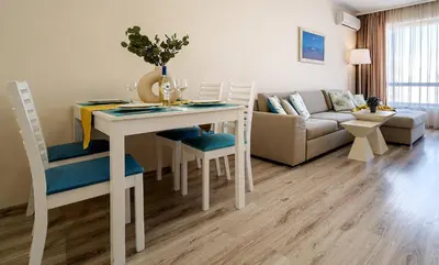 a living room with a table and chairs and a couch at Summertime in Varna South Bay Beach Residence in Varna City