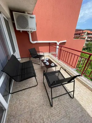 two chairs and a table on a balcony at Green Fort - Prestige Sea Viev apartments in Sunny Beach