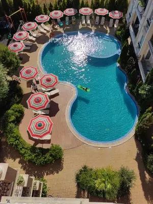 an overhead view of a swimming pool with umbrellas at Messembria Palace Bulgaria in Sunny Beach
