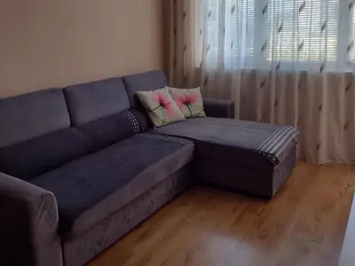 a blue couch with a ottoman in a living room at Messembria Palace Bulgaria in Sunny Beach