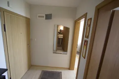 a room with a hallway with a mirror and a door at Apartmán Alex beach s nádherným panoramatickým výhledem na moře in Sveti Vlas