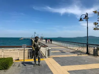 a statue of a man standing on a pier at Портхаус in Burgas City