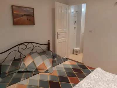 a bedroom with a bed with a checkerboard floor at Портхаус in Burgas City