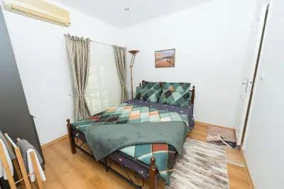 a small bedroom with a bed in a room at Портхаус in Burgas City