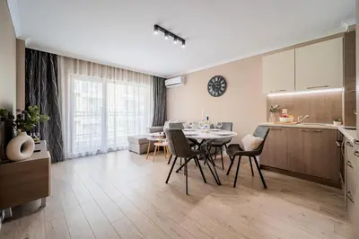 a kitchen and dining room with a table and chairs at Comfy luxury center apartment in Varna City