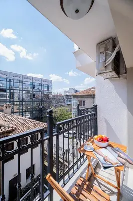 a balcony with a table and a bowl of fruit on it at Comfy luxury center apartment in Varna City