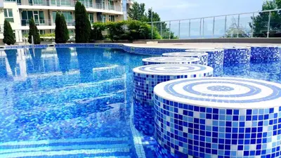 a swimming pool with blue and white tiles on it at Silver beach Studio Byala in Byala