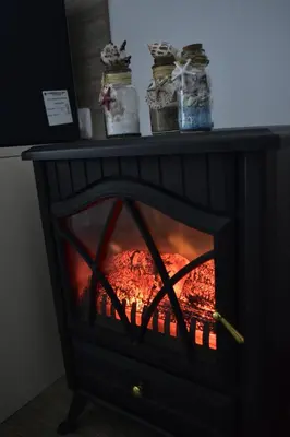 a fireplace with a fire inside of it at Silver beach Studio Byala in Byala