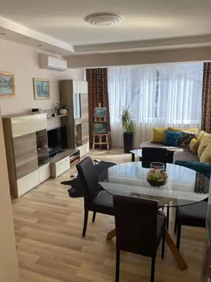 a living room with a table and a couch at Luxury family apartament in Burgas City