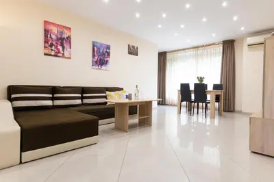 a living room with a couch and a table at BeCentral! by RV Apartments in Varna City