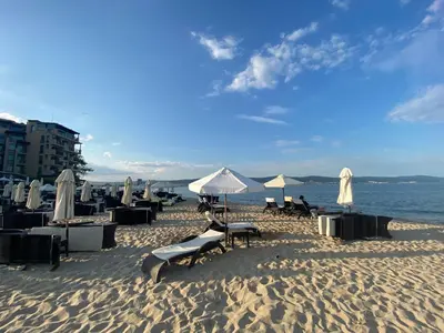 a beach with chairs and umbrellas on the sand at SUNNY VIEW CENTRAL 3401 Studio Sunny Beach in Sunny Beach