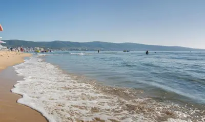 a beach with people walking in the water at SUNNY VIEW CENTRAL 3401 Studio Sunny Beach in Sunny Beach