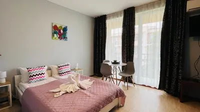 a bedroom with a bed with a flower on it at SUNNY VIEW CENTRAL 3401 Studio Sunny Beach in Sunny Beach