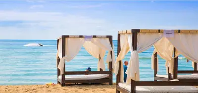 two beds on a beach with the ocean in the background at SUNNY VIEW CENTRAL 3401 Studio Sunny Beach in Sunny Beach
