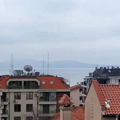 a view of the water from a city with buildings at Апартамент - студио в кв Сарафово с морски изглед in Burgas City