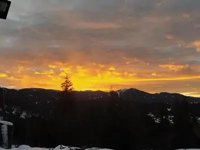 a sunset in the mountains with the sun setting at Апартамент - студио в кв Сарафово с морски изглед in Burgas City