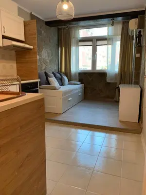 a kitchen and a living room with a couch at Анси in Pomorie
