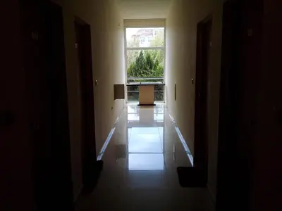 an empty hallway with a large window in a building at AFRODITA I 108 Studio Sunny Beach in Sunny Beach