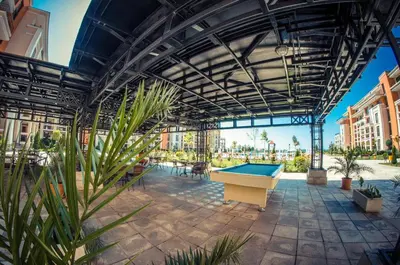 a pool table inside of a building with awning at Prestige Fort Beach - Premium apartments in Sveti Vlas