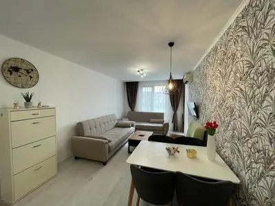 a living room with a table and a couch at Prestige Fort Beach - Premium apartments in Sveti Vlas