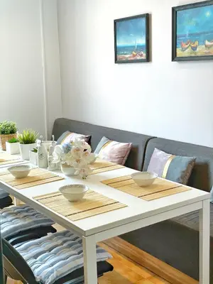 a white dining room table with bowls on it at Апартамент Компас in Burgas City