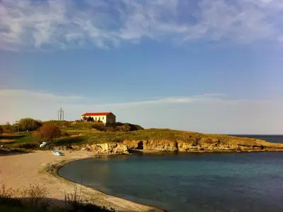 a small house on a small island in the water at Sea view apartment in Tsarevo