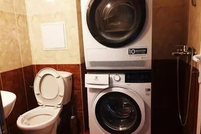 a bathroom with a washing machine and a speaker at Апартамент Диана in Pomorie