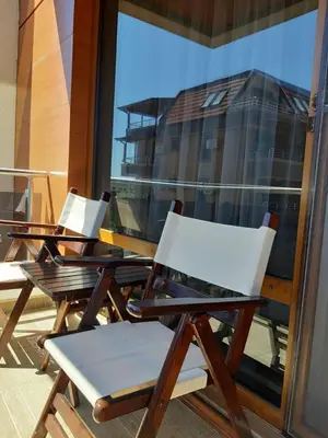 a group of chairs sitting on top of a balcony at Студио-