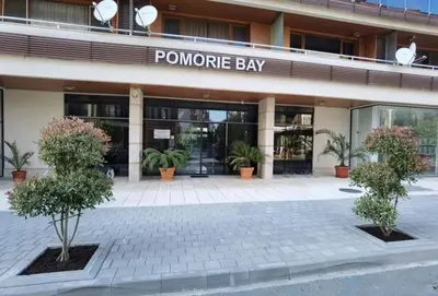 a building with a sign that reads pomegranate bay at Студио-