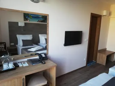 a hotel room with a mirror and a room with a bed at Hotel Vanilla, Varna - Free parking in Varna City
