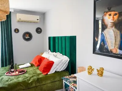 a room with a bed and a picture of a monkey at Nessebar Fort Club - Prestige Apartments in Sunny Beach