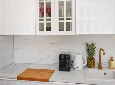 a white kitchen with a counter top with a toaster at Nessebar Fort Club - Prestige Apartments in Sunny Beach