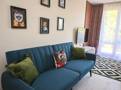 a blue couch with pillows in a living room at Nessebar Fort Club - Prestige Apartments in Sunny Beach