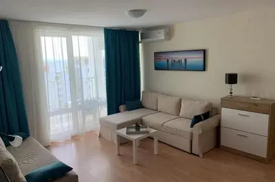 a living room with a couch and a table at Sea Fort Club & Grand Resort in Sveti Vlas