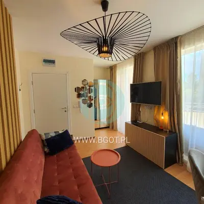 a living room with a couch and a tv at Grand Resort - Sea Viev and Premium Apartments in Sveti Vlas