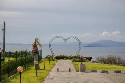 a heart gate on a path next to the ocean at Clara Studio in Sarafovo by Flаt Manаger in Burgas City