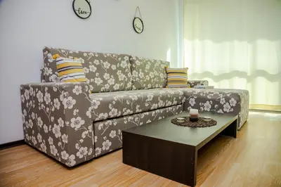 a living room with a couch and a coffee table at Clara Studio in Sarafovo by Flаt Manаger in Burgas City