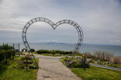 a heart shaped archway on a path near the ocean at Clara Studio in Sarafovo by Flаt Manаger in Burgas City
