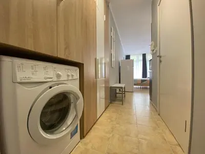 a washer and dryer in a room with a hallway at ANITA B16 Studio Sunny Beach in Sunny Beach
