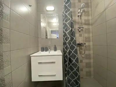 a bathroom with a white sink and a shower at ANITA B16 Studio Sunny Beach in Sunny Beach