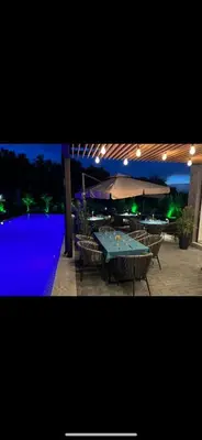 a patio with a table with chairs and an umbrella at Amara Sugar Hotel in Sunny Beach