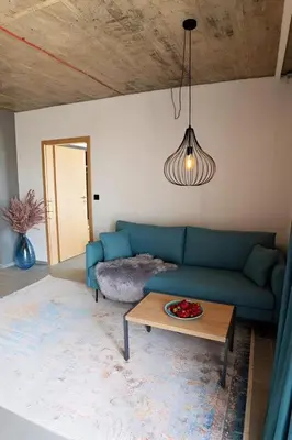 a living room with a blue couch and a table at Amara Sugar Hotel in Sunny Beach